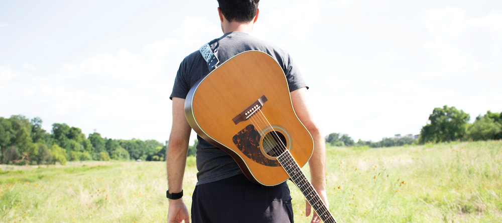 Guitarist playing in a field